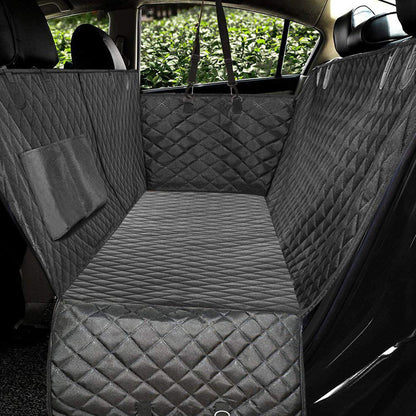 Gray quilted car seat cover in a vehicle with greenery outside